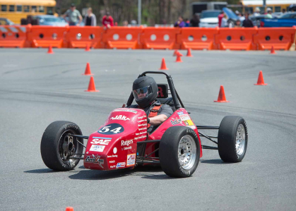 A driver tests a "Formula 1" car on Busch campus during Rutgers Day 2018.