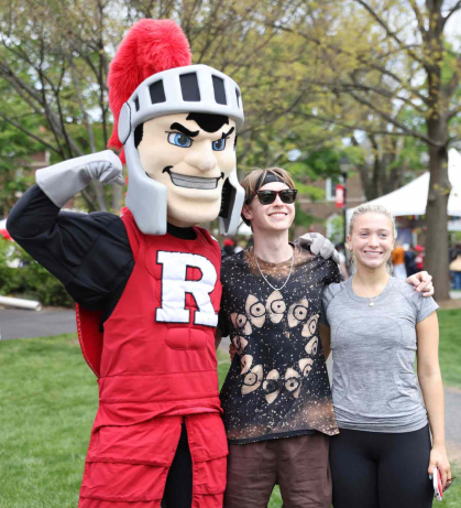Rutgers mascot Sir Henry (left) poses with young people during Rutgers Day 2024 on the College Avenue campus.