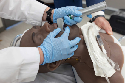 Amanda Sallemi practices a direct laryngoscopy for endotracheal intubation (or, in other words, placing a breathing tube) on an airway task trainer manikin.