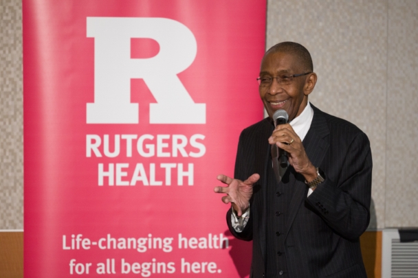 Dean Robert Johnson speaks into a microphone during the Integration Summit