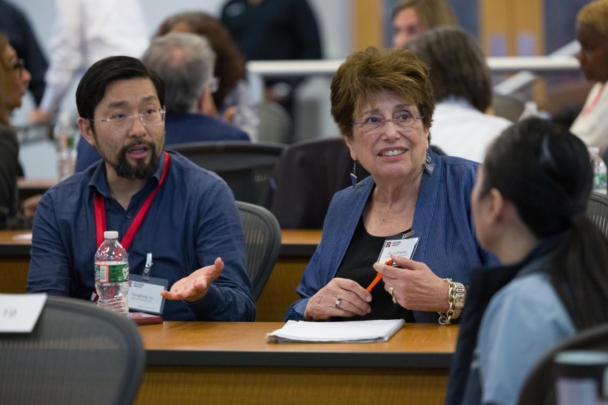 Participants talk in groups at the Integration Summit 