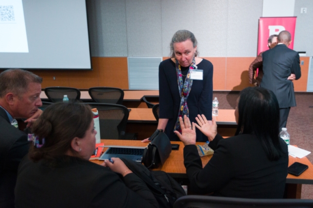 Participants talk in groups at the Integration Summit 