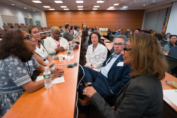 Participants talk in groups at the Integration Summit 