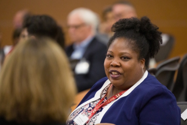 Participants talk in groups at the Integration Summit 