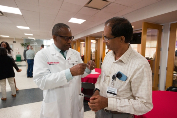 Participants talk in groups at the Integration Summit 