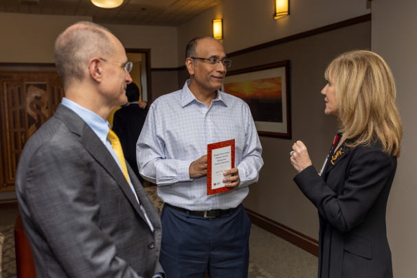Faculty attendees talk in a group at the Rising Star Ceremony in Newark.