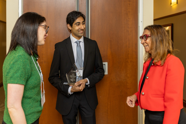 Attendees talk in a group at the Rising Star Ceremony in Newark.