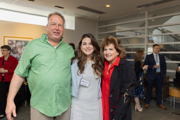Student takes a photo with her family at the Rising Star Ceremony in New Brunswick.