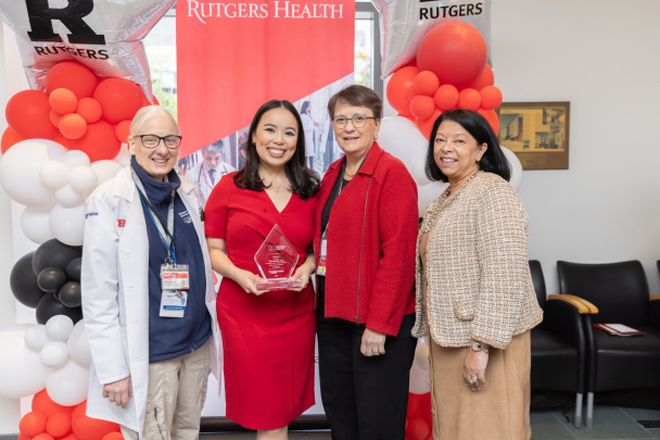 A student poses for a photo with faculty and Dean Murtha at the Rising Star Ceremony in New Brunswick.