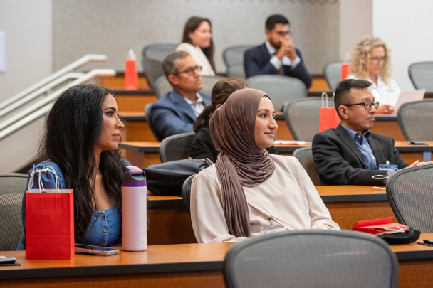 Attendees sitting in a lecture hall listen to a speaker during the 2026 Integration Summit in Newark
