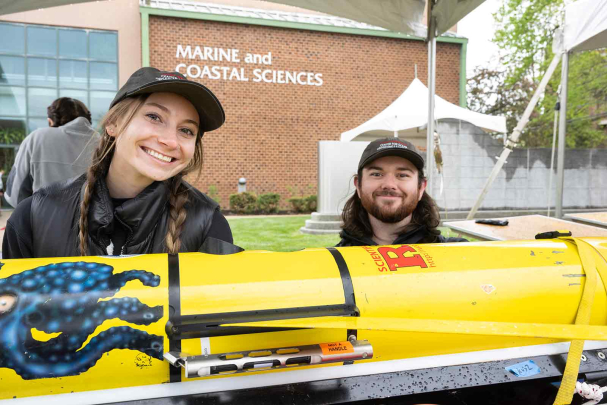 Rutgers students Jessica DeFeo (left) and Patrick Spezzuno work at the underwater glider display outside Marine and Coastal Studies during Rutgers Day on Cook campus.